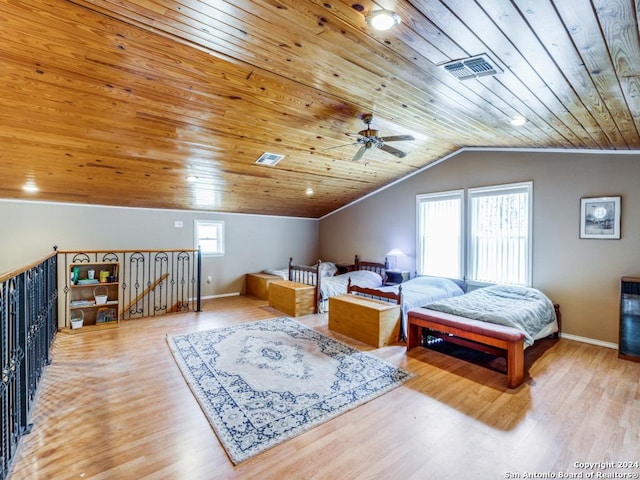 bedroom with lofted ceiling, wood ceiling, visible vents, and wood finished floors