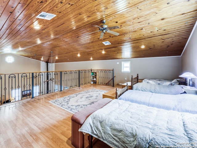 bedroom featuring wood ceiling, light hardwood / wood-style flooring, and lofted ceiling