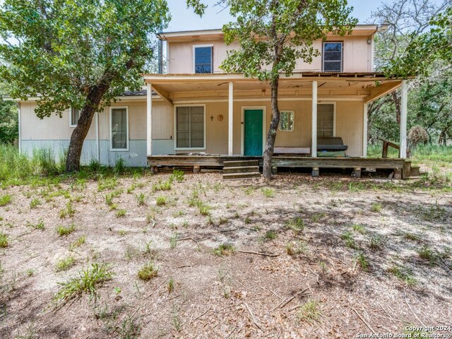 rear view of property featuring a porch