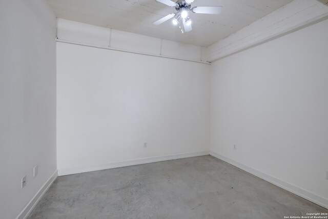 unfurnished bedroom featuring electric panel, concrete flooring, and ceiling fan