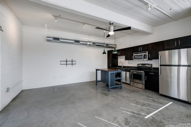 kitchen with appliances with stainless steel finishes, ceiling fan, and hanging light fixtures