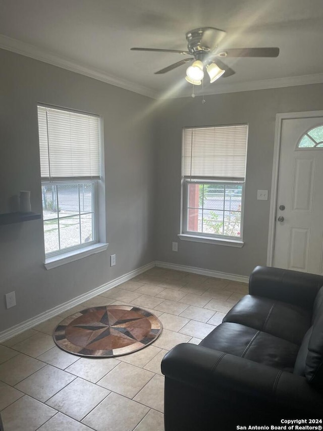 living room featuring ceiling fan, light tile patterned floors, and ornamental molding