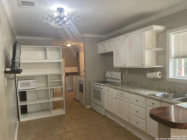 kitchen featuring dark tile patterned flooring, white appliances, white cabinetry, and ornamental molding