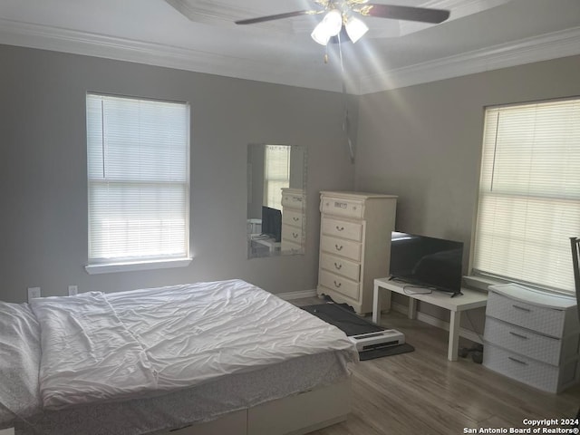 bedroom featuring ceiling fan, hardwood / wood-style floors, and ornamental molding