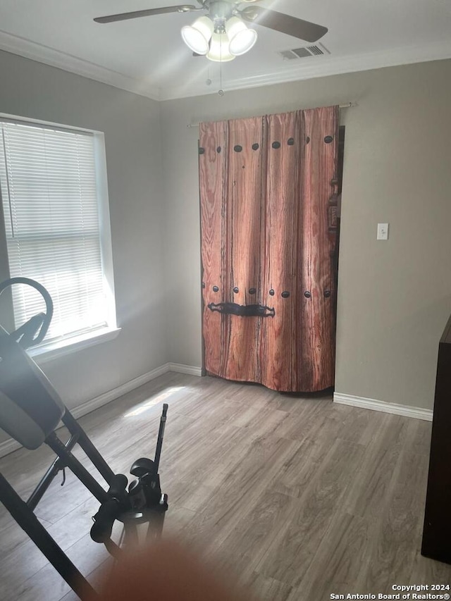 spare room featuring ceiling fan, ornamental molding, and light hardwood / wood-style flooring