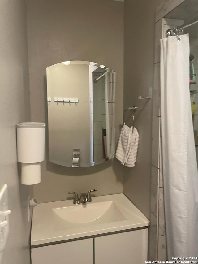 bathroom featuring curtained shower and sink