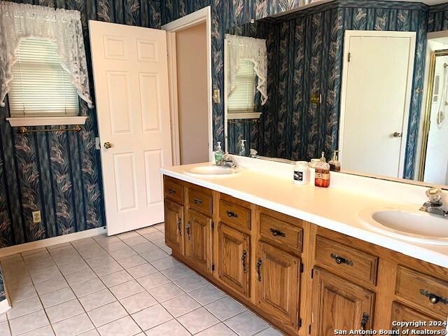 bathroom with vanity and tile patterned flooring