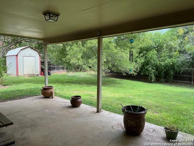 view of patio featuring a storage unit