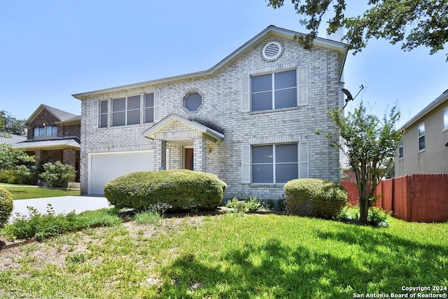 front of property featuring a garage and a front lawn