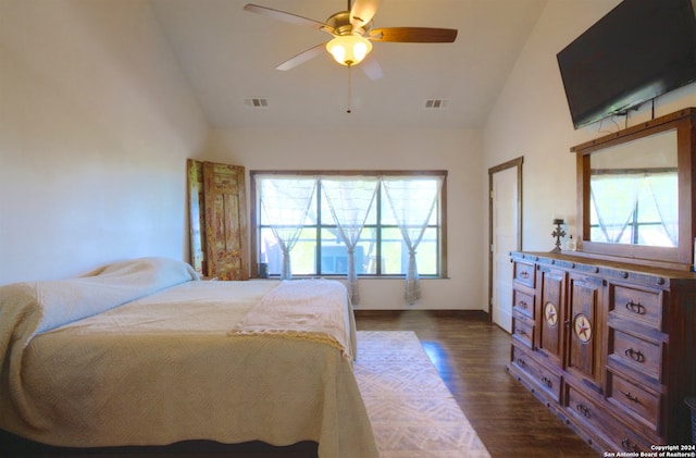 bedroom with ceiling fan, multiple windows, vaulted ceiling, and dark hardwood / wood-style flooring