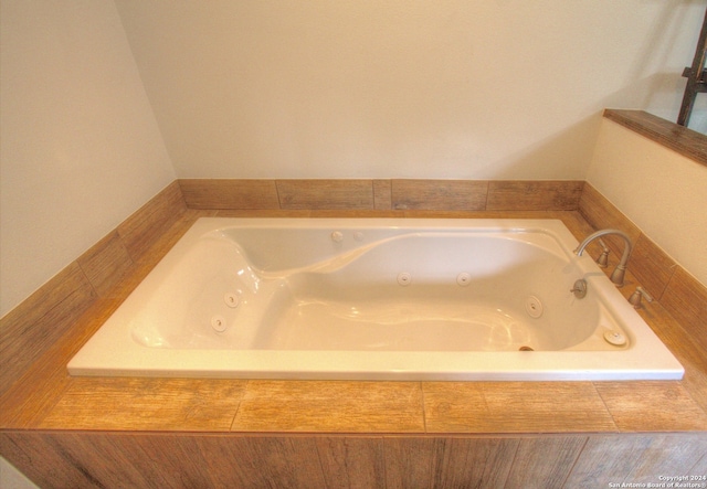 bathroom featuring tiled bath