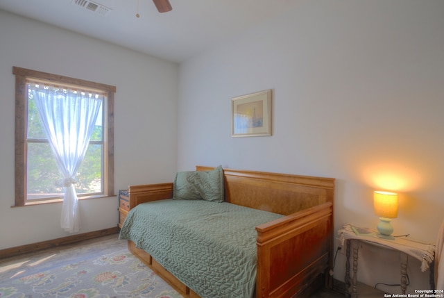 bedroom with multiple windows, hardwood / wood-style flooring, and ceiling fan