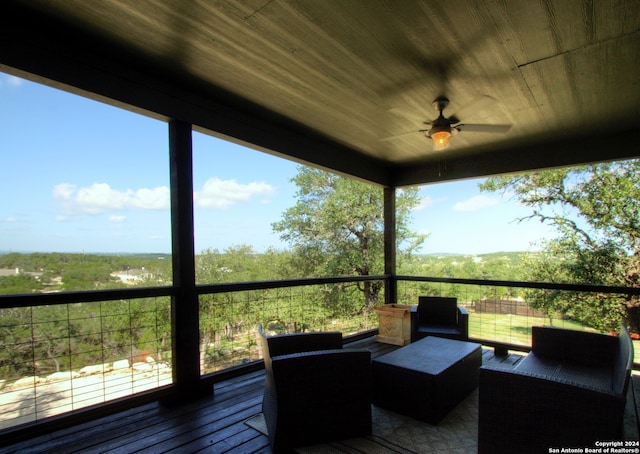 sunroom / solarium with a wealth of natural light, wooden ceiling, and ceiling fan