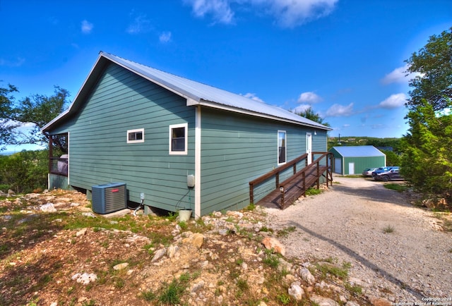 view of side of home with a storage unit and central AC unit