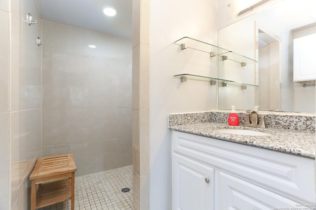 bathroom with vanity and tiled shower