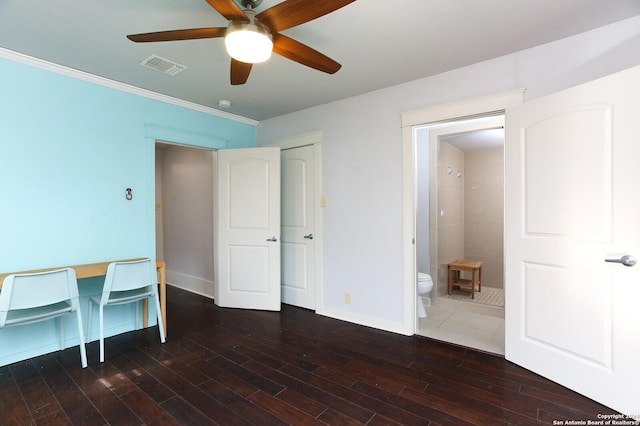 unfurnished office featuring ceiling fan, dark hardwood / wood-style flooring, and crown molding