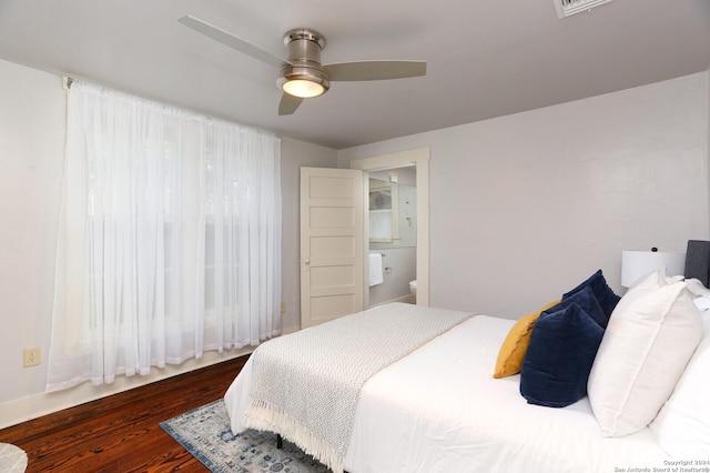 bedroom with ceiling fan, dark hardwood / wood-style floors, and ensuite bath