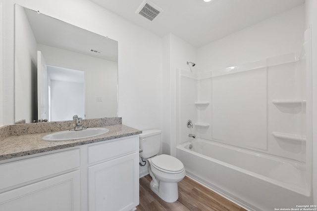 full bathroom featuring bathing tub / shower combination, toilet, vanity, and hardwood / wood-style flooring