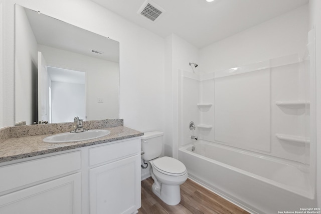 full bathroom featuring vanity, wood-type flooring, bathtub / shower combination, and toilet