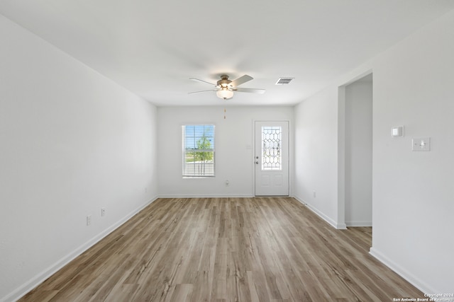 empty room featuring ceiling fan and light hardwood / wood-style floors