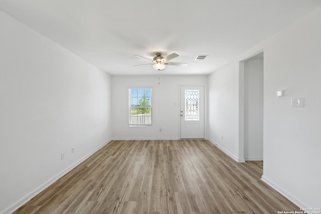 spare room featuring ceiling fan and light hardwood / wood-style flooring