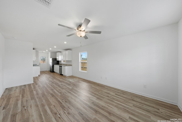 unfurnished living room with ceiling fan and light wood-type flooring