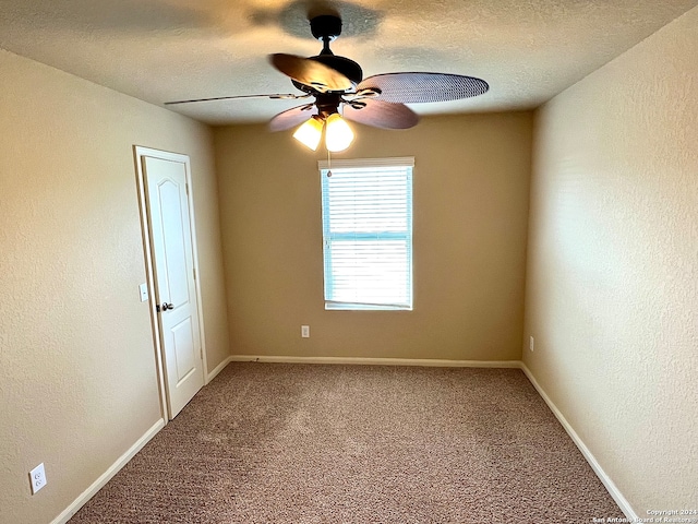 carpeted empty room with a textured ceiling and ceiling fan