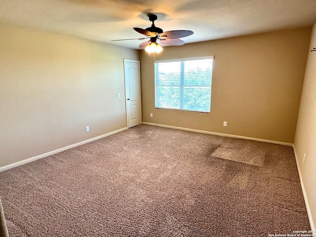 unfurnished room with carpet flooring and ceiling fan