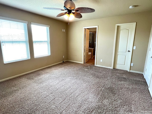 unfurnished bedroom with carpet floors, ensuite bathroom, and ceiling fan