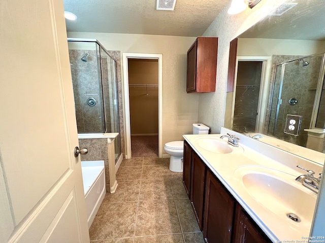 full bathroom with shower with separate bathtub, tile patterned floors, dual vanity, toilet, and a textured ceiling