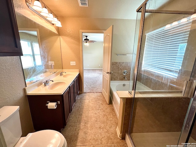 full bathroom with shower with separate bathtub, tile patterned floors, ceiling fan, dual vanity, and toilet