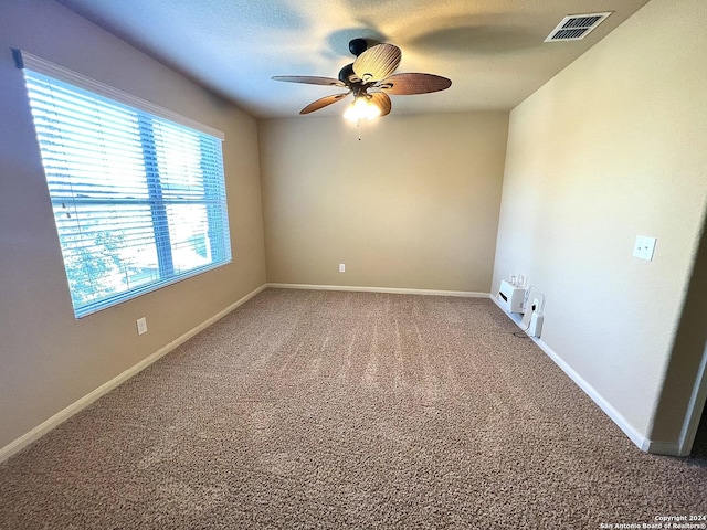 carpeted empty room featuring ceiling fan