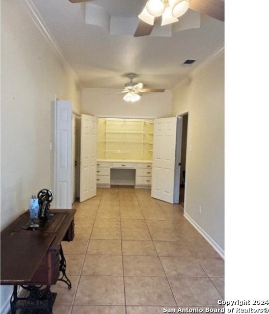 interior space with crown molding, ceiling fan, and light tile patterned floors