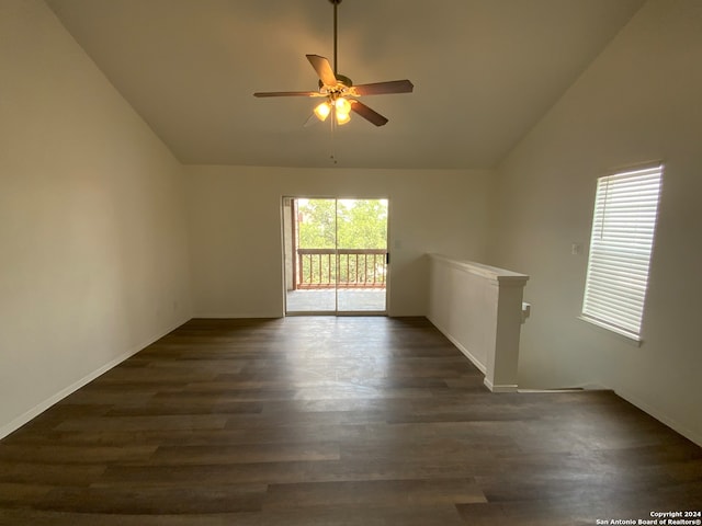 unfurnished room with lofted ceiling, ceiling fan, and dark wood-type flooring