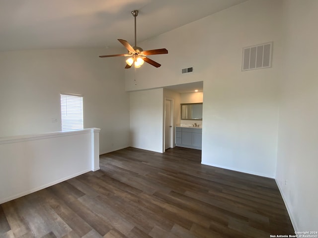 spare room featuring high vaulted ceiling, dark wood-type flooring, and ceiling fan