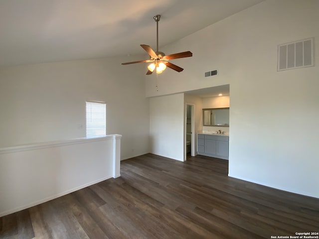 empty room with ceiling fan, dark wood-type flooring, and high vaulted ceiling