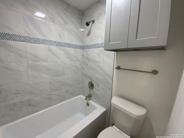 bathroom with tiled shower / bath and toilet