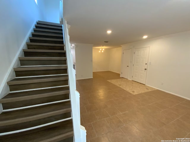 staircase featuring tile patterned flooring