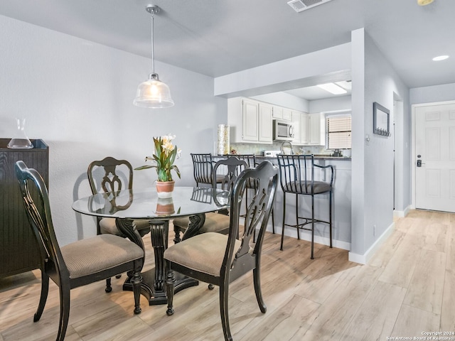 dining space featuring light wood-type flooring