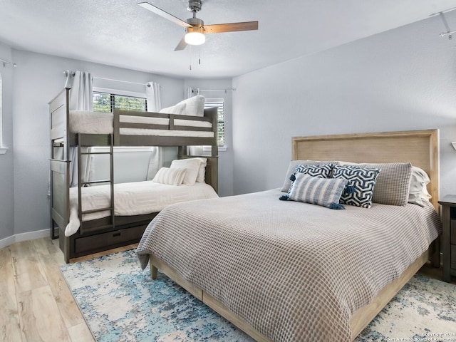 bedroom with ceiling fan and light hardwood / wood-style flooring