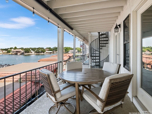 balcony featuring a water view