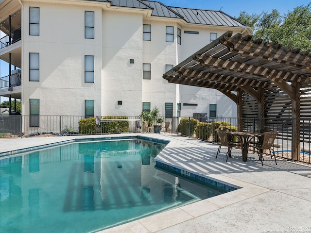 view of pool with a patio area and a pergola