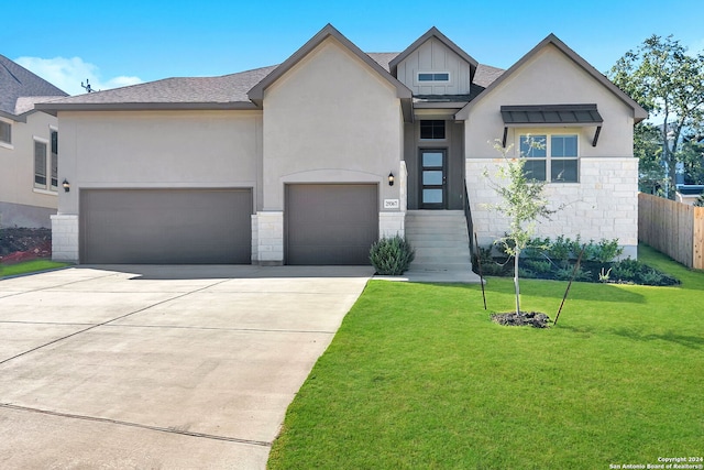 view of front of property with a front lawn and a garage