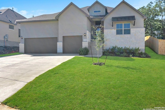 view of front of house featuring a garage and a front yard