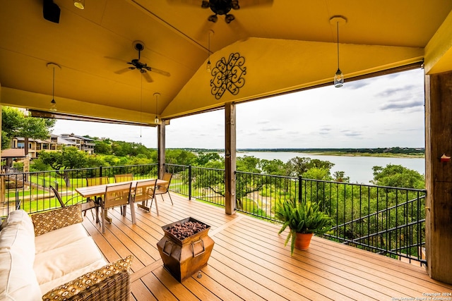 wooden deck with a water view and ceiling fan