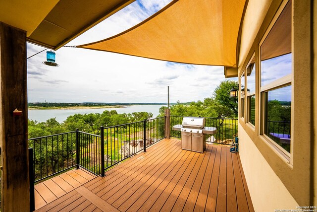 wooden deck with an outdoor hangout area and a water view