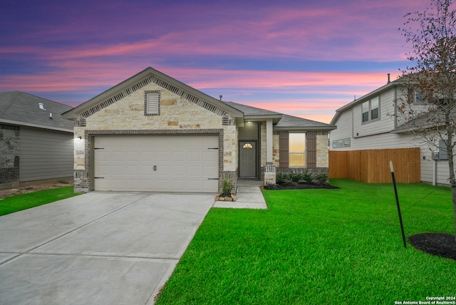 view of front of home with a garage and a yard