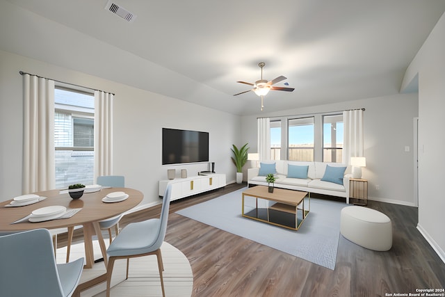 living room with lofted ceiling, ceiling fan, wood-type flooring, and a healthy amount of sunlight