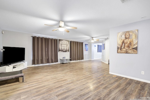 living room with hardwood / wood-style flooring and ceiling fan