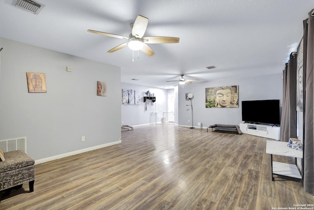 living room with ceiling fan and hardwood / wood-style floors